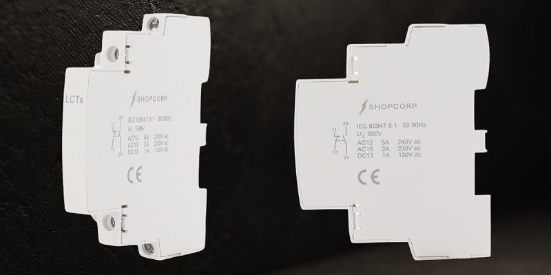Figure 2. Two clip‑on auxiliary contact blocks with NO/NC terminal markings, providing additional feedback signal points.