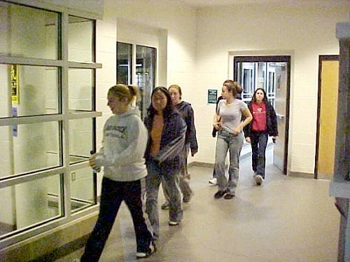 Much to their dismay, these students all know that this is only a fire drill and not a real fire; they will soon return to English class.